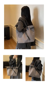 Close-up of matte grey tote bag with buckle detail and long black handles for daily commuting