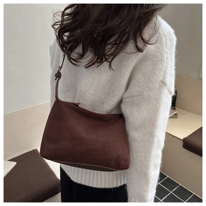Detailed view of the dark brown suede hobo tote with an adjustable shoulder strap