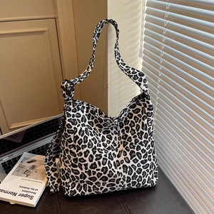Stylish black and white leopard print canvas tote bag with adjustable shoulder strap