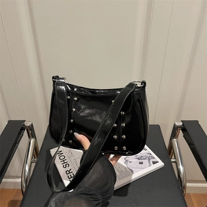 Minimalist black patent leather shoulder bag with vintage silver rivet studs and zip closure