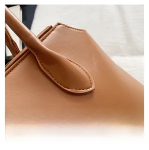 Close-up of caramel leather tote with precise stitching and refined texture