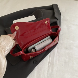Glossy red patent leather crossbody bag with interior space for phone and makeup