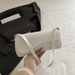 Glossy cream patent leather baguette bag for women with flap closure and shoulder strap