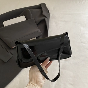 Glossy black patent leather baguette shoulder bag for women with minimalist sleek strap