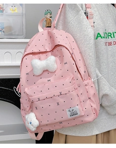 Pink polka dot backpack featuring a large plush bow and a cute cloud charm detail
