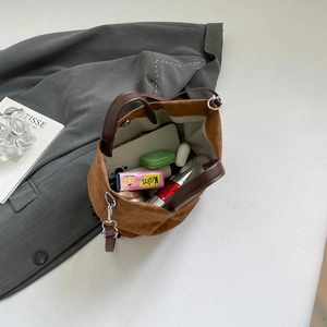Brown suede tote bag with large interior capacity and magnetic closure for daily commute