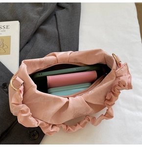 Pink ruched shoulder bag showing internal capacity for phone and wallet details