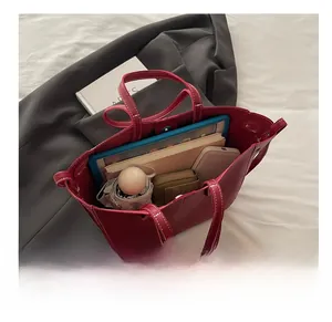 Interior view of large red tote bag showing storage for laptop and daily essentials