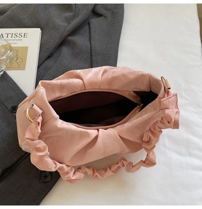 Top view of pink ruched shoulder bag showing zipper closure and interior space