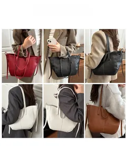Detail showing various colors and textures of large capacity bucket bags on a model