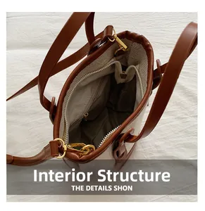 Top view of bucket bag interior featuring herringbone lining and a secure zipper pocket