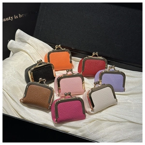 Mini kiss-lock jewelry pouches in 8 colors displayed on elegant white satin lining