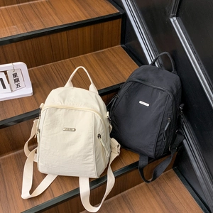Minimalist waterproof nylon travel backpack for men and women in black and beige colors