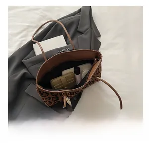 Detailed interior view of leopard print tote bag showing large capacity for essentials