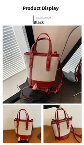 Detail of red and beige canvas bucket bag with adjustable shoulder strap and leather handles