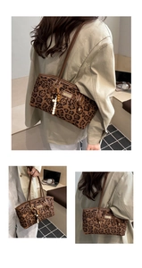 Detail of leopard print tote bag with beaded tassel charm and slim shoulder straps