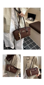 Detail of dark brown faux suede tote bag with wooden bead charm and fashion label