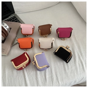 Detail of mini jewelry pouch showing various colors and lychee grain texture finish