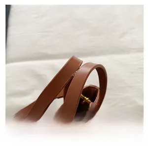 Detail of comfortable brown PU leather dual handles and metal zipper on bucket bag