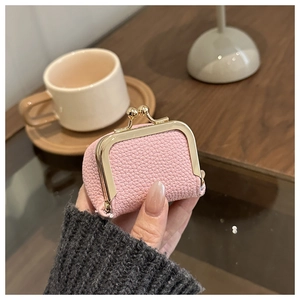 Pink lychee grain leather mini jewelry pouch with gold kiss-lock closure detail