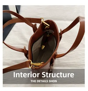 Detail view of brown PU leather bucket bag showing internal lining and zipper pocket