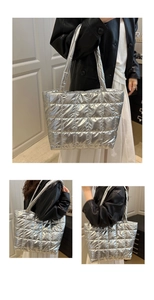 Silver quilted tote bag in metallic finish worn with leather jacket and long white skirt