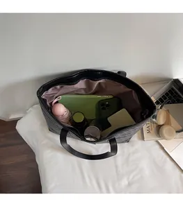 Interior view of spacious black monogram tote bag showing large storage capacity