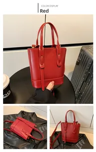 Detail of red leather bucket bag with top handle and adjustable shoulder strap