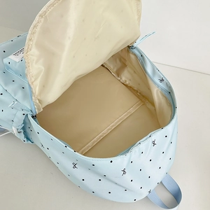 Light blue polka dot backpack with bow print showing spacious main compartment and lining