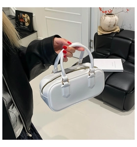 Detail of white PVC jelly boston bag with gold zipper and smooth leather texture