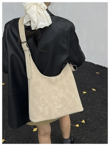 Detail of cream-colored large capacity hobo shoulder bag with textured faux leather finish