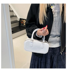Detail of a white glossy PVC jelly bag with a top handle and metallic zipper closure