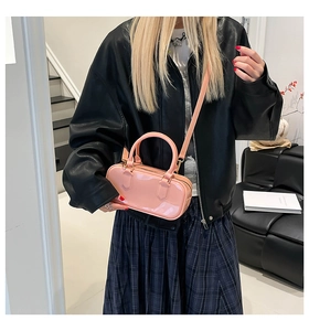 Pink candy-colored PVC pillow bag with gold hardware shown as a stylish crossbody bag