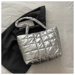Top-down view of silver quilted tote bag with metallic waterproof coating and large capacity