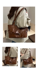 Detailed view of dark brown retro PU leather tote bag with silver rivets and metal buckle