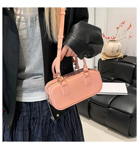 Detailed view of pink PVC jelly bag with top handles and adjustable shoulder strap