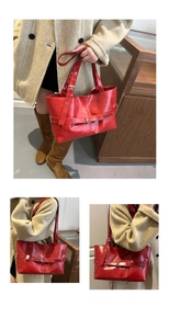 Detailed view of red glossy leather tote bag with decorative buckle straps for women
