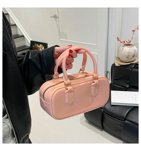 Detailed view of pink PVC jelly handbag with golden zipper and rounded handles