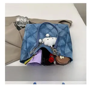 Top view of blue denim tote bag interior showing large capacity for umbrella and notebook
