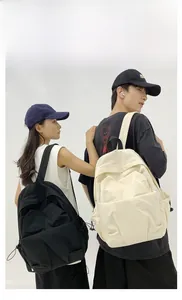 Front view of black and beige large capacity minimalist backpacks on male and female models