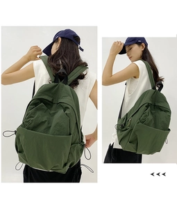 Detail view of durable military green large-capacity nylon backpack with drawstring pockets