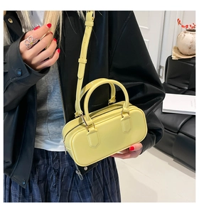 Detailed view of yellow candy jelly pillow bag with golden hardware and top handles