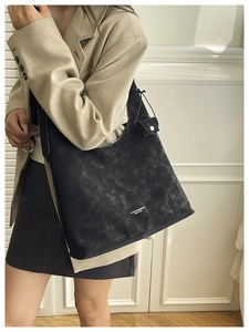 Detail of black tote bag with vintage texture and detachable small coin purse pouch