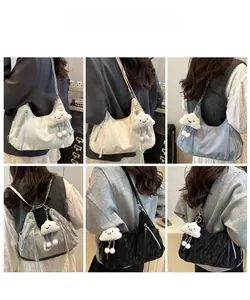 Detailed back view of multi-color nylon shoulder bags featuring plush cloud pendants