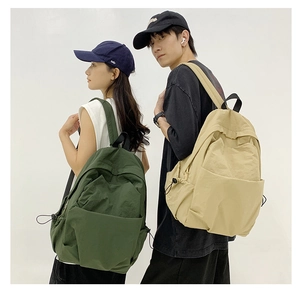 Deep green and beige nylon backpacks shown on male and female models for travel