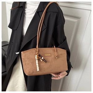 Brown faux suede tote bag featuring a Fashion metal logo and a wooden bead tassel charm