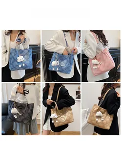 Quilted tote bags in blue, pink, and black with cloud charms and metal chains