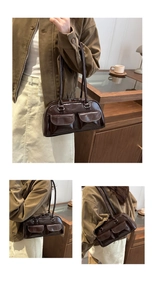 Detail view of dark brown glossy leather underarm bag with double front flap pockets