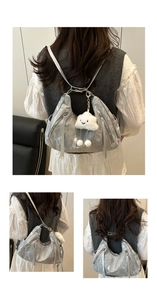Detail of silver metallic tote with pleated texture, side zipper and white cloud charm