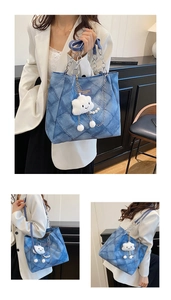 Detail of blue denim tote bag featuring quilted diamond pattern and plush cloud charm